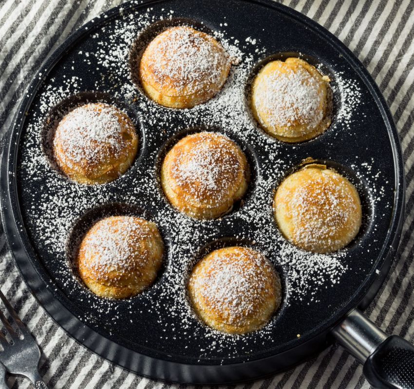 Pfannkuchen in einer Pfanne mit Puderzucker.